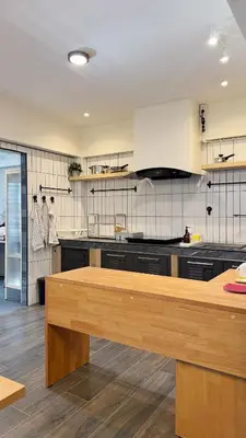a kitchen with a wooden counter top in a room at Hyde Residence Ladprao48 in Bangkok