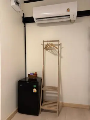 a room with a heater and a black refrigerator at Hyde Residence Ladprao48 in Bangkok