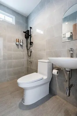 a bathroom with a toilet and a sink at Coco59- Private 3BR Pool Villa in Bangkok