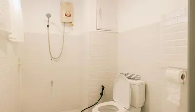 a white bathroom with a toilet and a shower at City Silom I King Bed I Sleep 3 I 2 Bedroom in Bangkok