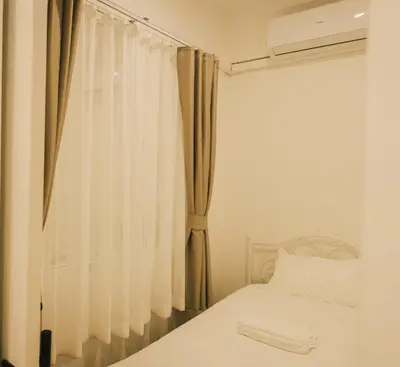 a bedroom with a bed and a window with curtains at City Silom I King Bed I Sleep 3 I 2 Bedroom in Bangkok