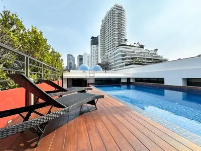 a swimming pool on the roof of a building at Stylish Low-rise 1BR - Ultra Fast WiFi - BTS Thonglor in Bangkok