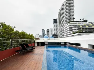 a swimming pool on the roof of a building at Stylish Low-rise 1BR - Ultra Fast WiFi - BTS Thonglor in Bangkok