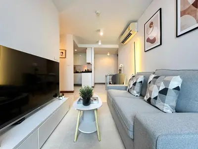 a living room with a couch and a table at Stylish Low-rise 1BR - Ultra Fast WiFi - BTS Thonglor in Bangkok