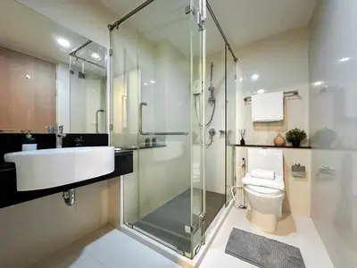 a bathroom with a shower and a sink and a toilet at Stylish Low-rise 1BR - Ultra Fast WiFi - BTS Thonglor in Bangkok