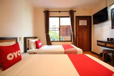 a hotel room with two beds and a television at Pannee Lodge Khaosan - SHA Plus in Bangkok