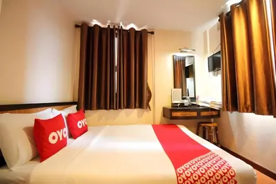 a hotel room with a bed with red pillows at Pannee Lodge Khaosan - SHA Plus in Bangkok
