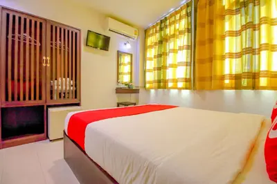 a bedroom with a large bed and a television at Super OYO 484 Pannee Residence Khaosan Sha Plus in Bangkok
