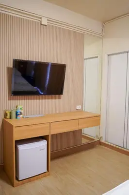 a room with a desk with a television on a wall at Apartment Near Big Buddha in Bangkok Yai