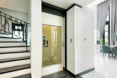 a glass door in a house with a dining room at Stylish 7Beds Poolhouse with Cinema Lift - 2min to BTS in Amphoe Phra Khanong