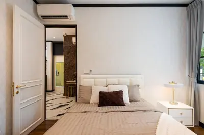 a bedroom with a large bed and a mirror at Stylish 7Beds Poolhouse with Cinema Lift - 2min to BTS in Amphoe Phra Khanong
