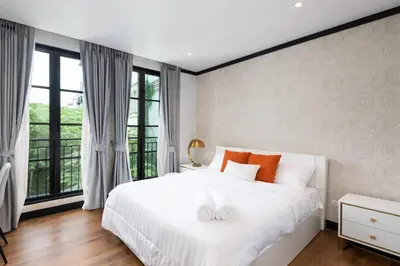a bedroom with a white bed and a large window at Stylish 7Beds Poolhouse with Cinema Lift - 2min to BTS in Amphoe Phra Khanong