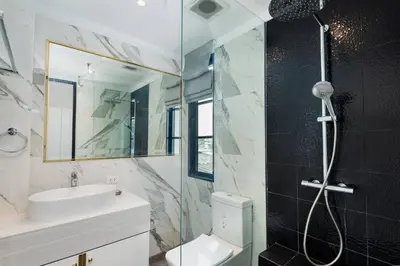 a bathroom with a sink toilet and a shower at Stylish 7Beds Poolhouse with Cinema Lift - 2min to BTS in Amphoe Phra Khanong