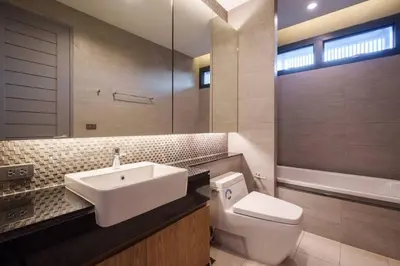 a bathroom with a sink and a toilet and a tub at MonochromeDesignerPool Villa in Bangkok