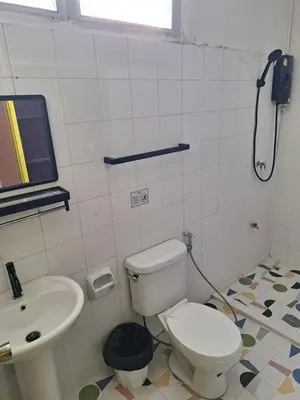 a bathroom with a toilet and a sink at Happy 2 Hotel Patunam in Bangkok