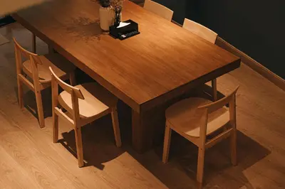 a wooden table with four chairs and a wooden table with at HAUS 924 l 5-Level Sanctuary in Ekkamai in Bangkok