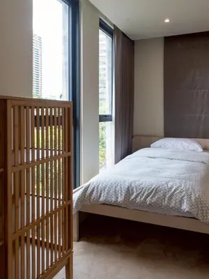 a bedroom with a bed and a large window at Shizuka House - 500 m walk to BTS Phrom Phong in Bangkok