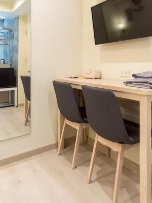 a desk with two chairs in a room at Shizuka House - 500 m walk to BTS Phrom Phong in Bangkok
