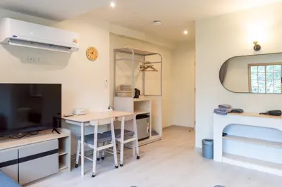 a living room with a desk and a tv at Shizuka House - 500 m walk to BTS Phrom Phong in Bangkok