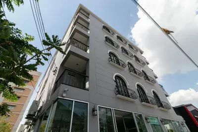 a white building with windows on the side of it at Resortel Lat Phrao 91 in Bangkok