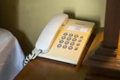 a white phone sitting on a table at Elite Home stays by UPAR, Silom in Bangkok