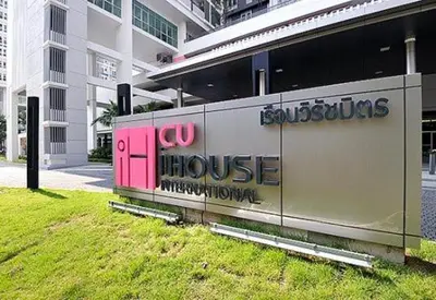 a building with a sign on the side of it at CU iHouse เรือนวิรัชมิตร in Bang Rak