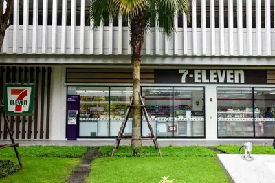 a tripod in front of a store with a palm tree at CU iHouse เรือนวิรัชมิตร in Bang Rak