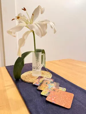 a white flower in a vase on a table at Cozy Cat Souluna home in Ekkamai in Bangkok