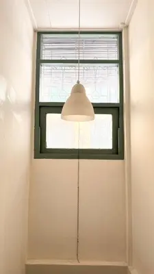 a room with a window and a light fixture at Cozy Cat Souluna home in Ekkamai in Bangkok