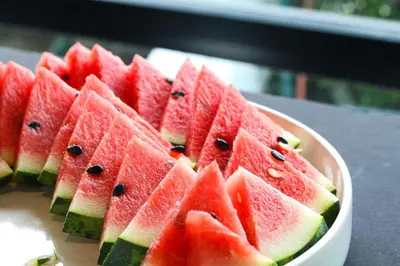 a plate of watermelon slices on a table at The Riche Boutique Hotel Don Mueang Airport in Bangkok