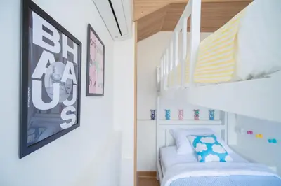 a bedroom with a bunk bed and a staircase at Via Baan Sathorn, City-Center Apartment With Private Rooftop Near BTS in Bangkok