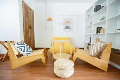 a living room with chairs and a table at Via Baan Sathorn, City-Center Apartment With Private Rooftop Near BTS in Bangkok