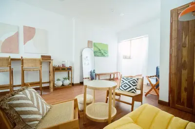 a living room with a couch and chairs and a table at Via Baan Sathorn, City-Center Apartment With Private Rooftop Near BTS in Bangkok