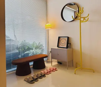 a room with a bench and a bunch of shoes at Charming Minimal 3BR Home Near BTS Ari, Bangkok in Sathani Bang Su
