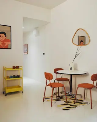 a table and chairs in a room with a mirror at Charming Minimal 3BR Home Near BTS Ari, Bangkok in Sathani Bang Su