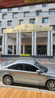 a silver car parked in front of a building at Tawan Room#5 in Bangna