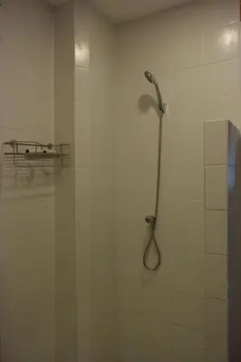 a shower with a shower head in a bathroom at Tawan Room#6 in Bangna