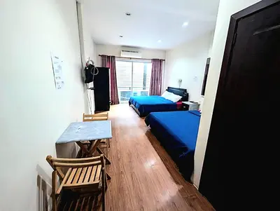 a bedroom with a bed and a table and chairs at Asia Mahanakhorn Travel in Bangkok