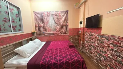 a small room with a bed with a purple blanket at Asia Mahanakhorn Travel in Bangkok