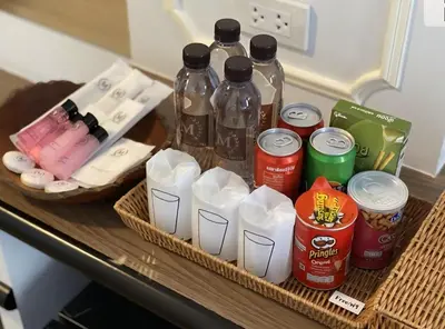 a shelf with bottles of alcohol and other condiments at Asia Mahanakhorn Travel in Bangkok