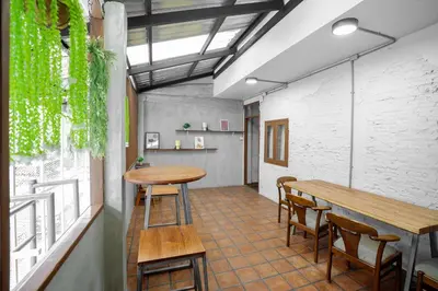 a room with a table and chairs and a counter at Siam Breeze Inn - Self Check-in in Bangkok