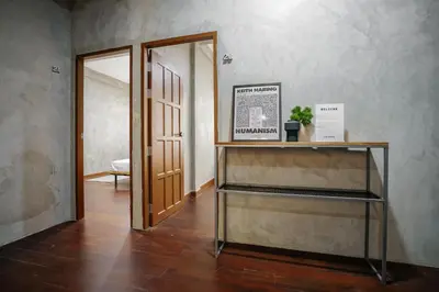 a room with a door and a shelf with a plant at Siam Breeze Inn - Self Check-in in Bangkok