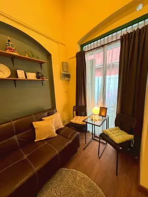 a living room with a couch and a window at Hansa Heritage home in Khao San in Bangkok