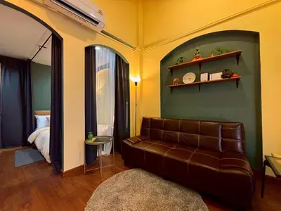 a living room with a couch and a bed at Hansa Heritage home in Khao San in Bangkok