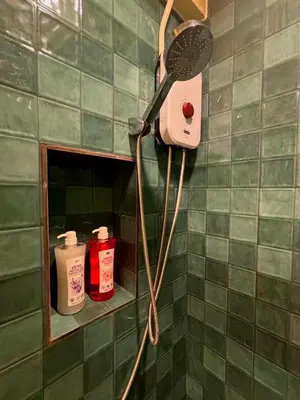 a shower with a blow dryer in a bathroom at Hansa Heritage home in Khao San in Bangkok