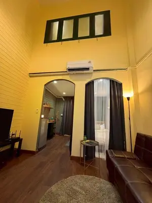 a living room with a couch and a window at Hansa Heritage home in Khao San in Bangkok