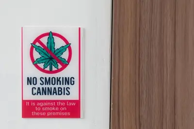 a no smoking sign on a wall next to a door at Ease at Sathorn Hostel and Coworking Space in Bangkok