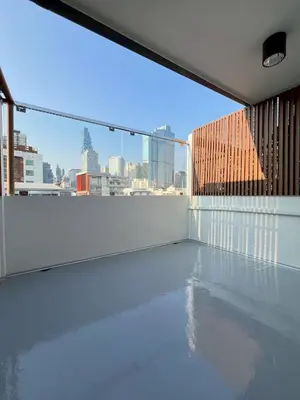 a balcony with a view of a city skyline at Ease at Sathorn Hostel and Coworking Space in Bangkok