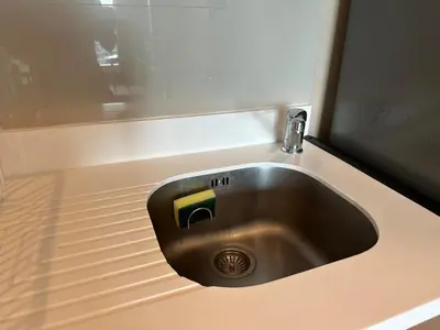 a stainless steel sink in a counter top at Condo, 3-min walk to BTS, Sky pool, Gym, Wifi, Self check-in at pickup point in Bangkok