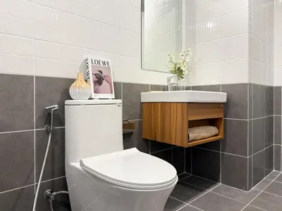 a bathroom with a toilet and a sink at Stylish Tropical l 2BR - Ultra Fast Wifi - Sathorn in Bangkok